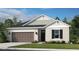 Charming single-story home with a well-manicured lawn, two-car garage and attractive architectural details at 553 Moon Shell Cir, New Smyrna Beach, FL 32168