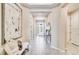 Bright hallway features stylish decor, tiled floors, and an inviting view of the entry door at 553 Moon Shell Cir, New Smyrna Beach, FL 32168