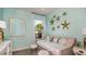 Charming bedroom with a daybed, starfish wall decor, and soft, coastal-inspired colors at 556 Moon Shell Cir, New Smyrna Beach, FL 32168