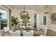 Formal dining room featuring modern chandelier, elegant decor, and a large window for natural light at 556 Moon Shell Cir, New Smyrna Beach, FL 32168