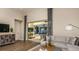 Spacious living room with hardwood floors, contemporary furniture, and sliding glass doors to the patio at 556 Moon Shell Cir, New Smyrna Beach, FL 32168