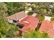 Aerial view showing the home's terracotta tile roof, screened patio and neighborhood at 7 Forest Ln, Eustis, FL 32726