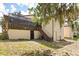 Exterior of home with a screened-in patio and staircase to the backyard at 7 Forest Ln, Eustis, FL 32726