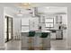 Modern kitchen with a large island, stainless steel appliances, white cabinetry, and an open design at 7 Forest Ln, Eustis, FL 32726