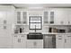 Stylish kitchen with white cabinets, stainless steel appliances, modern sink, and a sleek design at 7 Forest Ln, Eustis, FL 32726