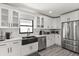 Well-lit kitchen featuring stainless steel appliances, white cabinets, and sleek fixtures at 7 Forest Ln, Eustis, FL 32726