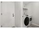 Bright laundry room equipped with a washer and dryer near the entry door at 7 Forest Ln, Eustis, FL 32726