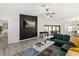 Spacious living room with accent wall, ceiling fan, and view of the backyard at 7 Forest Ln, Eustis, FL 32726