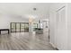 Spacious living room showcasing wood flooring, an island with barstools and access to an outdoor deck at 7 Forest Ln, Eustis, FL 32726