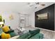 Well-lit living room featuring a plush green sofa, modern art, and light hardwood floors at 7 Forest Ln, Eustis, FL 32726