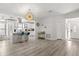Bright open-concept living area featuring wood floors, modern lighting, and a stylish kitchen view at 7 Forest Ln, Eustis, FL 32726