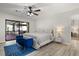 Comfortable main bedroom featuring a ceiling fan, and a sliding glass door to patio at 7 Forest Ln, Eustis, FL 32726