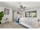 Well-lit bedroom featuring wood-look floors, and glass doors to the backyard patio at 7 Forest Ln, Eustis, FL 32726