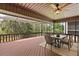 Covered patio with outdoor dining area offering a view of lush greenery at 7 Forest Ln, Eustis, FL 32726