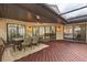 Covered patio with outdoor dining set and access to the home's interior at 7 Forest Ln, Eustis, FL 32726