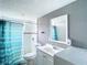 Bathroom featuring a modern vanity, toilet, shower with a turquoise curtain, and modern mirror at 734 Michigan Ct # 2, St Cloud, FL 34769