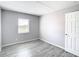 Bright bedroom featuring neutral walls, sleek gray flooring, and a window with bright natural light at 734 Michigan Ct # 2, St Cloud, FL 34769