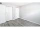Bright bedroom featuring neutral walls, sleek gray flooring, and white closet doors at 734 Michigan Ct # 2, St Cloud, FL 34769