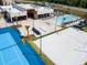 Aerial view showcasing tennis and volleyball courts along with pool and lounge area at 7513 Brooklyn Dr, Kissimmee, FL 34747