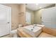 Bright bathroom with a square sink, tan stone countertop, and white doors at 7513 Brooklyn Dr, Kissimmee, FL 34747