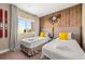 Inviting bedroom with twin beds, wood accent wall, and decorative skis at 7513 Brooklyn Dr, Kissimmee, FL 34747