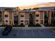 Modern townhome complex with large windows, clean lines, and ample parking at sunset at 7513 Brooklyn Dr, Kissimmee, FL 34747