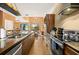 Open-concept kitchen with stainless steel appliances, a large island, and easy access to the living area at 7513 Brooklyn Dr, Kissimmee, FL 34747