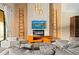 Bright living room with a modern fireplace, unique wall decor, and comfortable seating at 7513 Brooklyn Dr, Kissimmee, FL 34747
