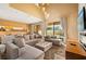 Spacious living room with plush seating, ambient lighting, and sliding glass doors to the outdoors at 7513 Brooklyn Dr, Kissimmee, FL 34747