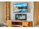 Cozy living room with electric fireplace, mounted television, and stylish stone accent wall at 7513 Brooklyn Dr, Kissimmee, FL 34747