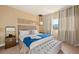 Comfortable main bedroom with a king bed, bench, accent lighting, and neutral decor at 7513 Brooklyn Dr, Kissimmee, FL 34747