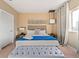 Bright main bedroom with a king bed, bench, accent lighting, and neutral decor at 7513 Brooklyn Dr, Kissimmee, FL 34747