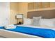 Comfortable main bedroom with a king bed featuring crisp white linens and a bright blue throw at 7513 Brooklyn Dr, Kissimmee, FL 34747