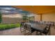 Charming outdoor patio offers a barbecue area, dining table, and comfortable couch, perfect for entertaining at 7513 Brooklyn Dr, Kissimmee, FL 34747