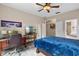 This cozy bedroom offers a comfortable sleeping area, a convenient workspace, and ample storage space at 7672 Torino Ct, Orlando, FL 32835