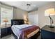 Traditional bedroom featuring neutral decor, a ceiling fan and a large window allowing for natural light at 7672 Torino Ct, Orlando, FL 32835