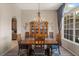 Dining room with chandelier, large window and view to the kitchen at 7672 Torino Ct, Orlando, FL 32835