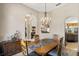 Dining room with chandelier, sideboard and view to the living room at 7672 Torino Ct, Orlando, FL 32835