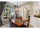 Dining room with chandelier, large window and view to the living room at 7672 Torino Ct, Orlando, FL 32835