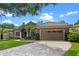 Charming home features a tile roof, manicured lawn and two car garage at 7672 Torino Ct, Orlando, FL 32835
