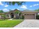 Charming home features a tile roof, manicured lawn and two car garage at 7672 Torino Ct, Orlando, FL 32835