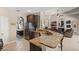 Granite countertop kitchen with stainless appliances and a view of the living room at 7672 Torino Ct, Orlando, FL 32835