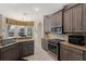 Modern kitchen featuring stainless appliances and breakfast bar that looks into the breakfast nook at 7672 Torino Ct, Orlando, FL 32835