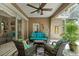 Relaxing screened-in lanai featuring stylish seating, ceiling fan, and tranquil outdoor views at 7672 Torino Ct, Orlando, FL 32835