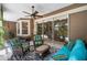 Spacious screened-in lanai featuring a seating area, ceiling fan, and views of the pool at 7672 Torino Ct, Orlando, FL 32835