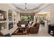 Inviting living room features fireplace, neutral tones, and views of the pool area at 7672 Torino Ct, Orlando, FL 32835