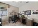 This home office space boasts neutral decor, multiple workstations, and great lighting at 7672 Torino Ct, Orlando, FL 32835