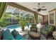 Inviting screened-in lanai with refreshing pool, comfortable seating, and lush tropical landscaping at 7672 Torino Ct, Orlando, FL 32835