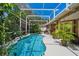 Lush landscaping surrounds this sparkling pool in a screened in backyard at 7672 Torino Ct, Orlando, FL 32835