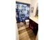 Bathroom with wood floor, floral shower curtain, and dark wood vanity at 811 Fairview Ave, Altamonte Springs, FL 32701